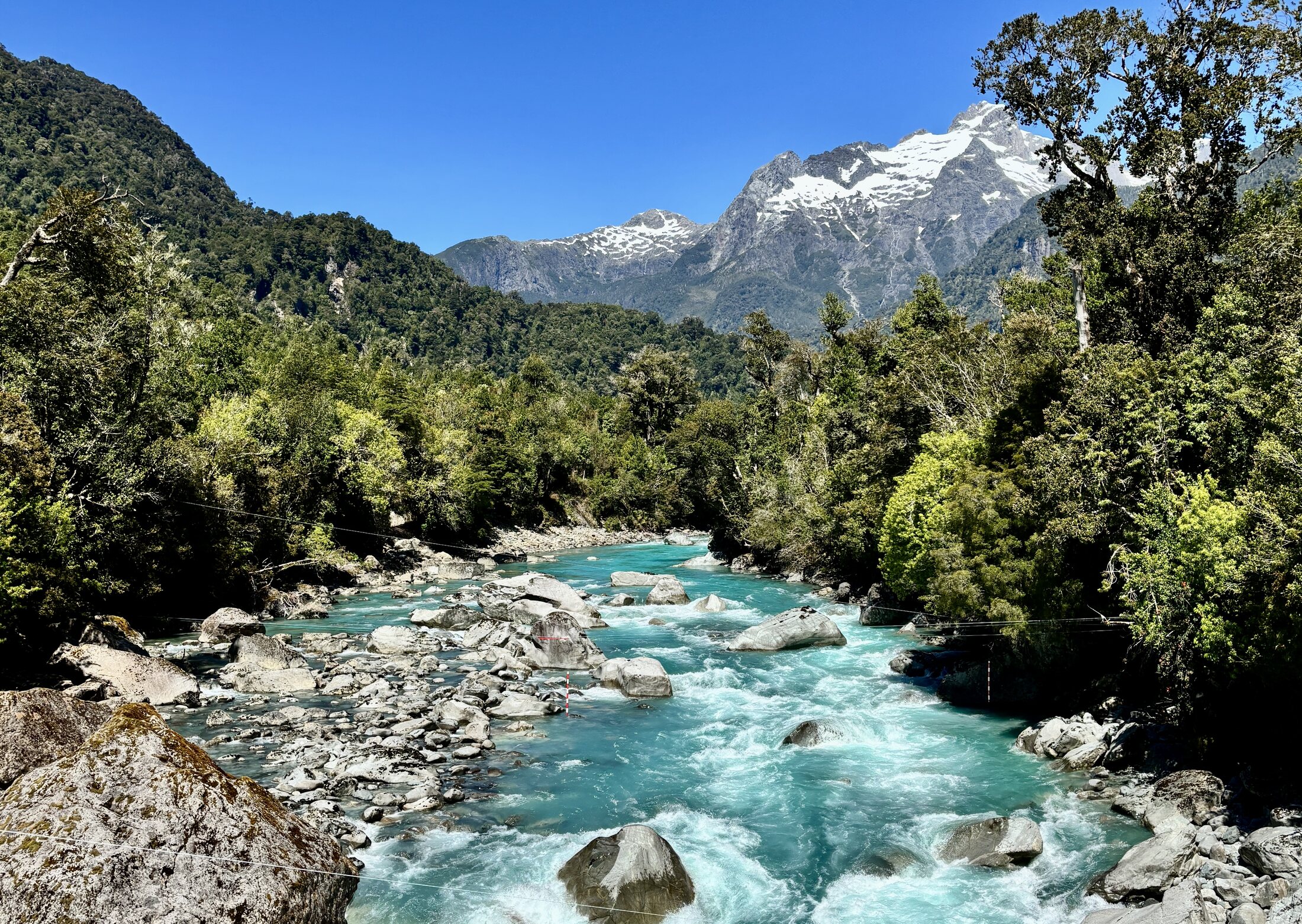 Turquoise river and forested mountains in Chile